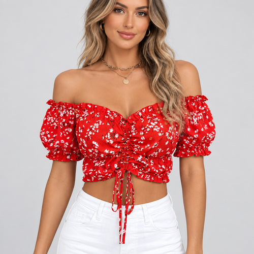 Red floral off-shoulder top worn by a person with a blurred background