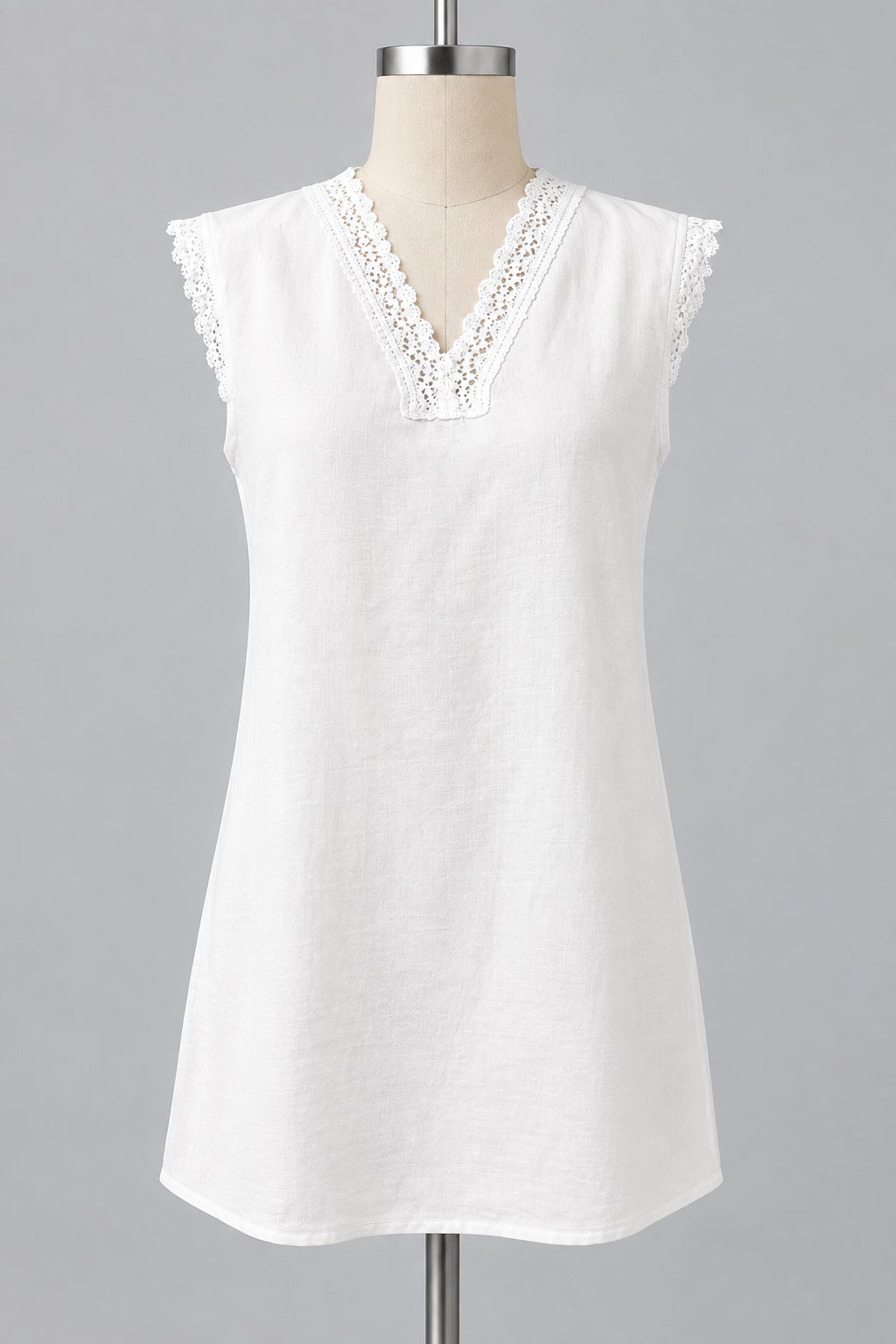 An off-white sleeveless tunic top with a lace V-neckline and lace trim on the shoulders, displayed on a dress form mannequin in an indoor setting.